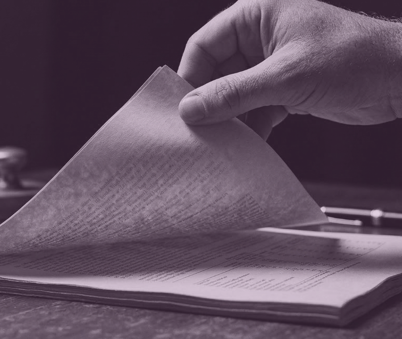 career repositioning feature image of a man's hand slowly turning the page from a block of paper. Symbolic of turning the next page of their career.