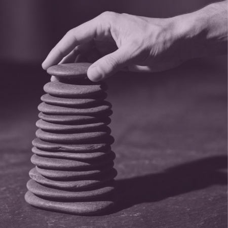 featured image for program Career Update Pathway. Features a hand building a tower of stones.