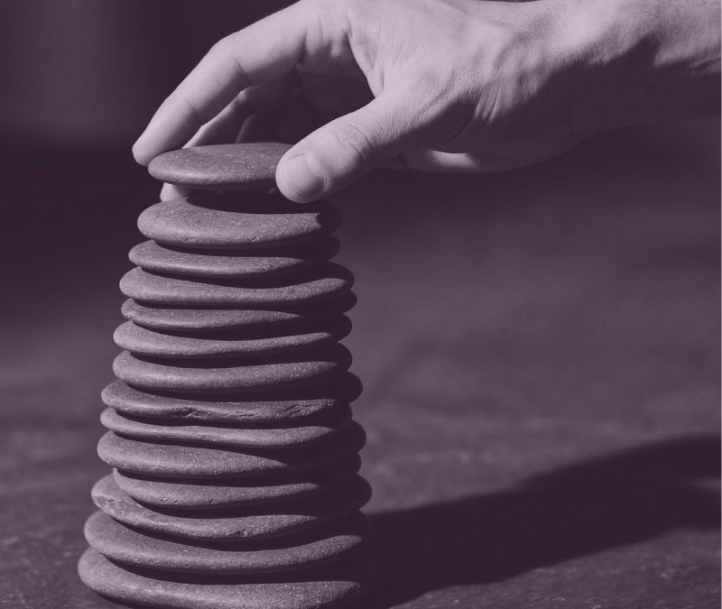featured image for program Career Update Pathway. Features a hand building a tower of stones.