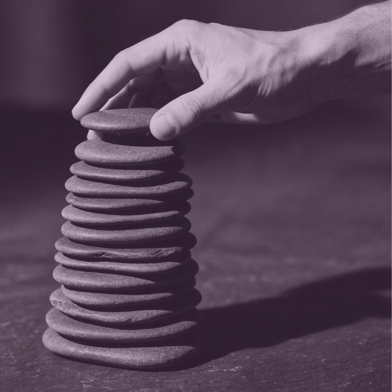 featured image for program Career Update Pathway. Features a hand building a tower of stones.
